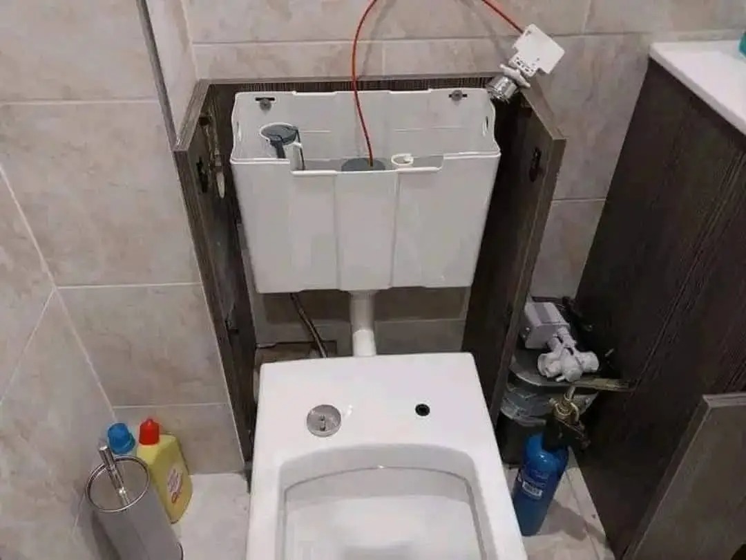 Concealed toilet cistern neatly boxed into a tiled bathroom