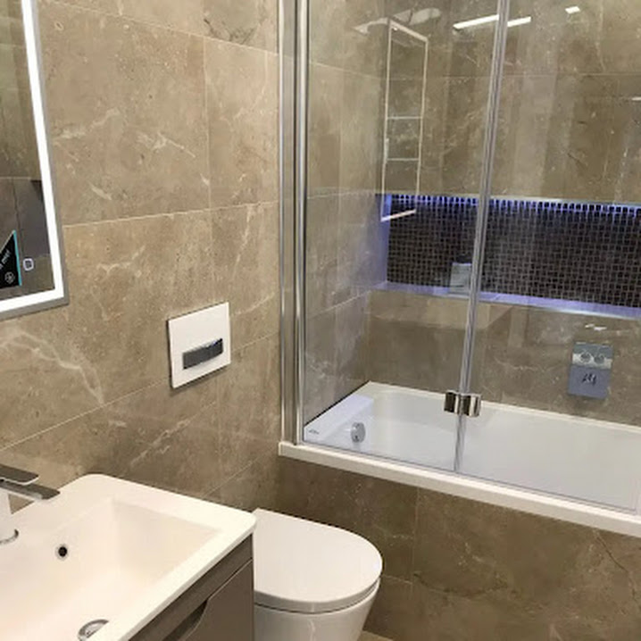 A finished bathroom with shower over bath, glass screen and new vanity