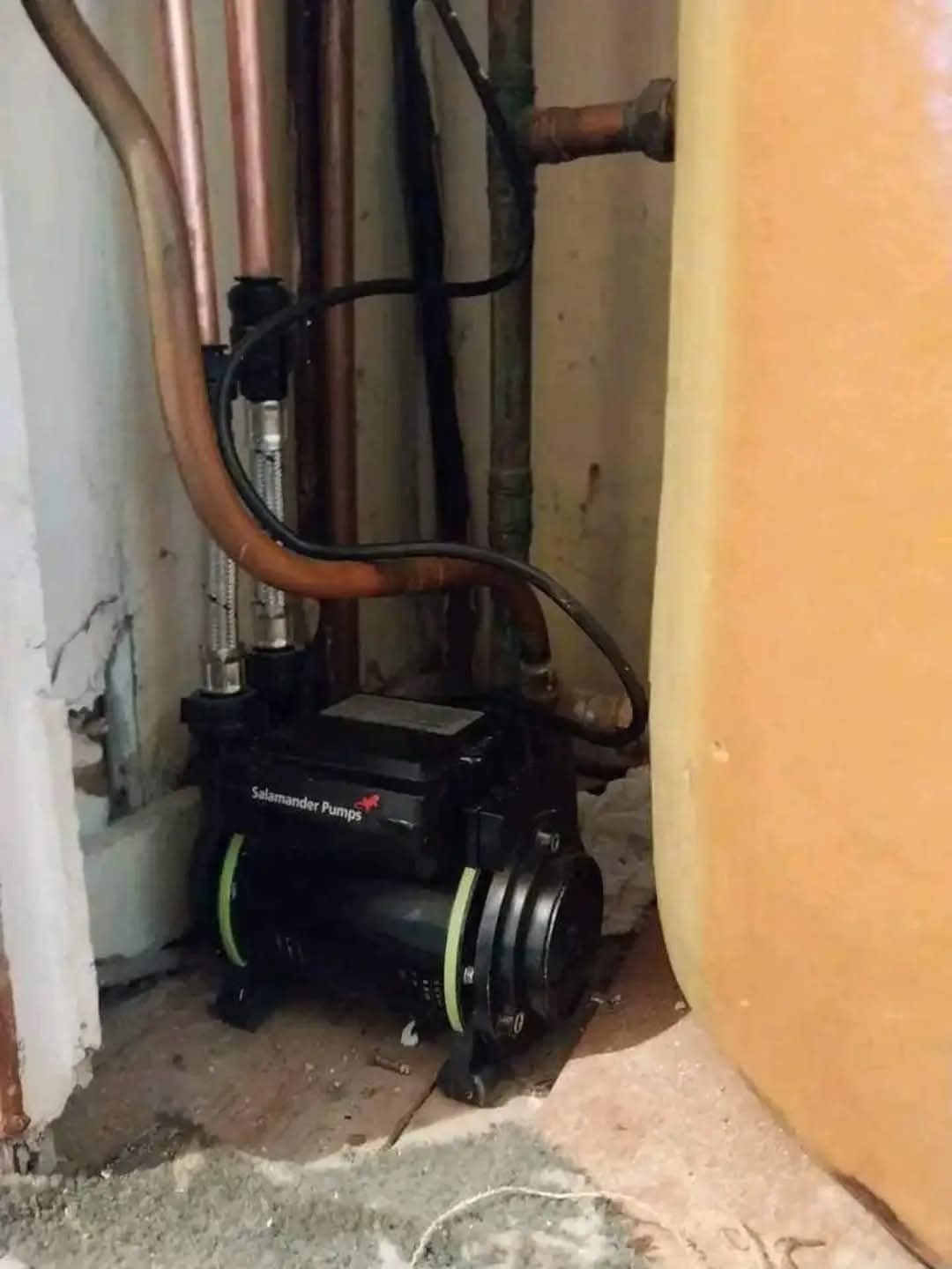 Salamander shower pump installed next to a hot water cylinder